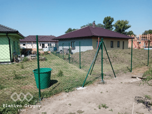Plot z běžného pletiva kolem rodinného domu