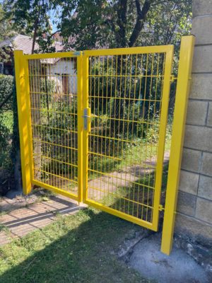Žlutá branka u vstupu na zahradu v soukromém objektu